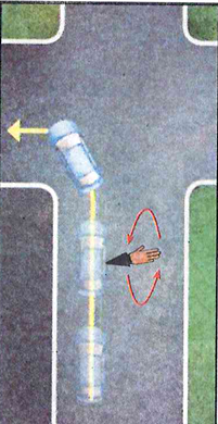 Turning left: well over to the left, with the arm signal for the turn.